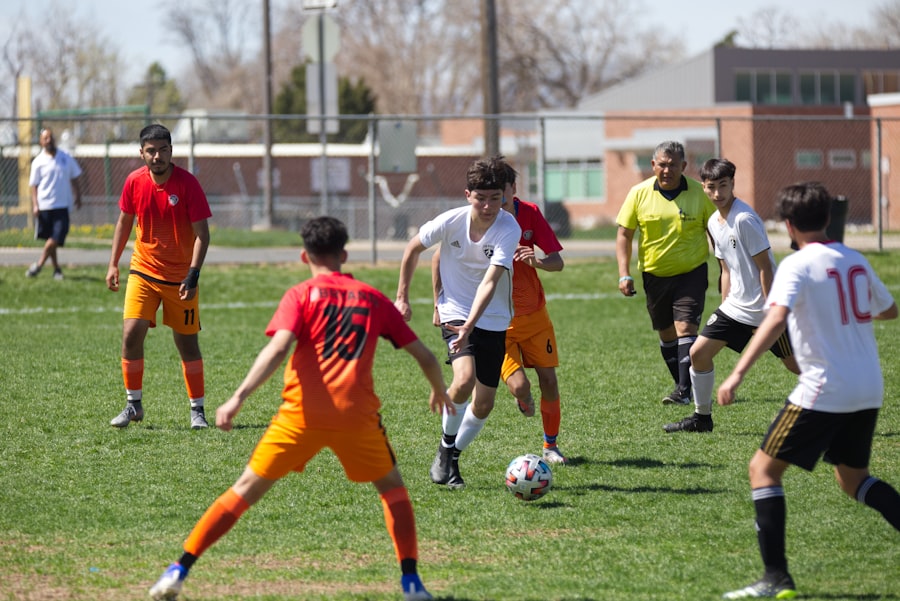 A group of young men playing soccer on a field during a sunny day.