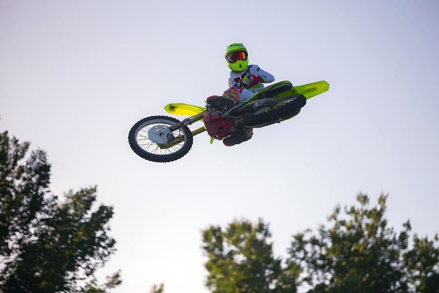 A person performing a stunt on a dirt bike mid-air.