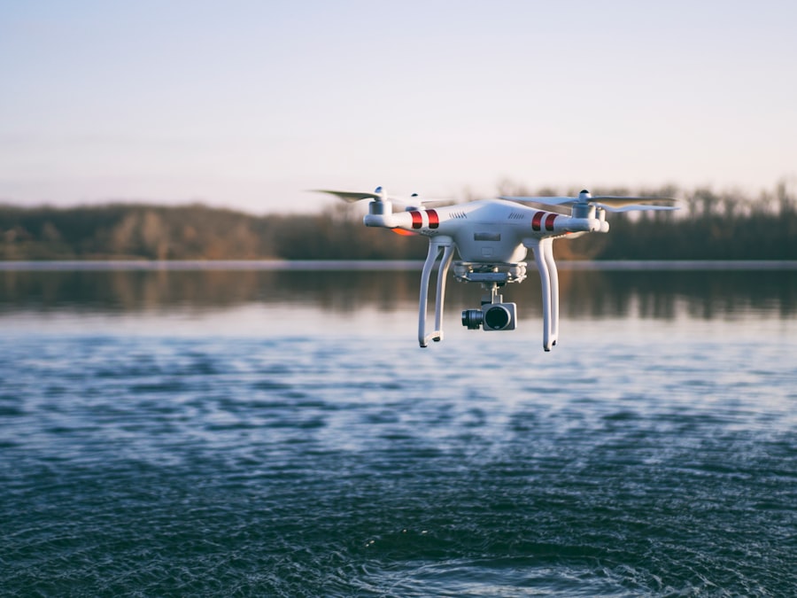 A white drone hovers above a serene body of water, capturing a breathtaking aerial view.