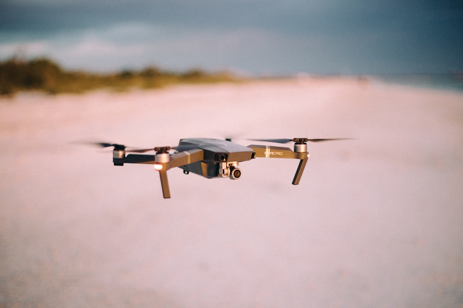  A small drone hovering above sandy beach, capturing scenic view.