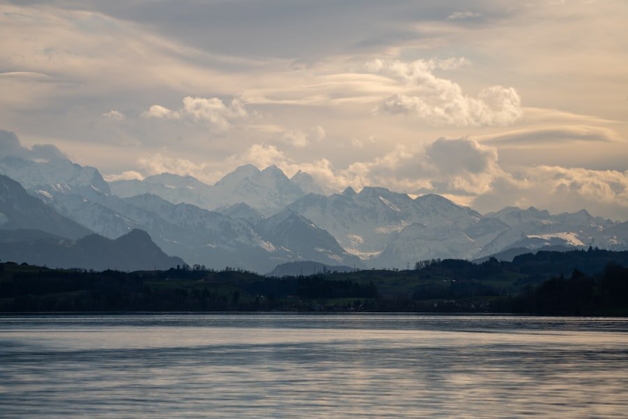 A serene lake with towering mountains in the distance.